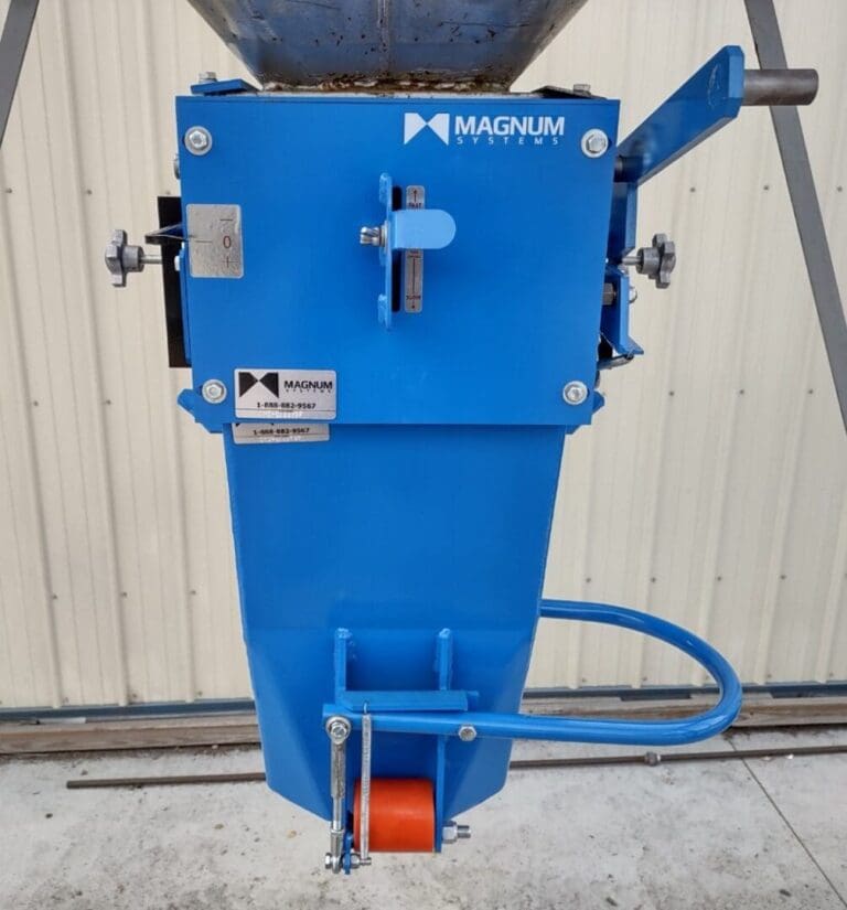 A blue machine is sitting outside near a building.