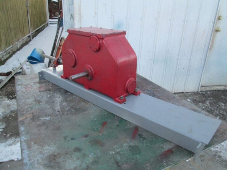 A red and gray machine is sitting on the ground