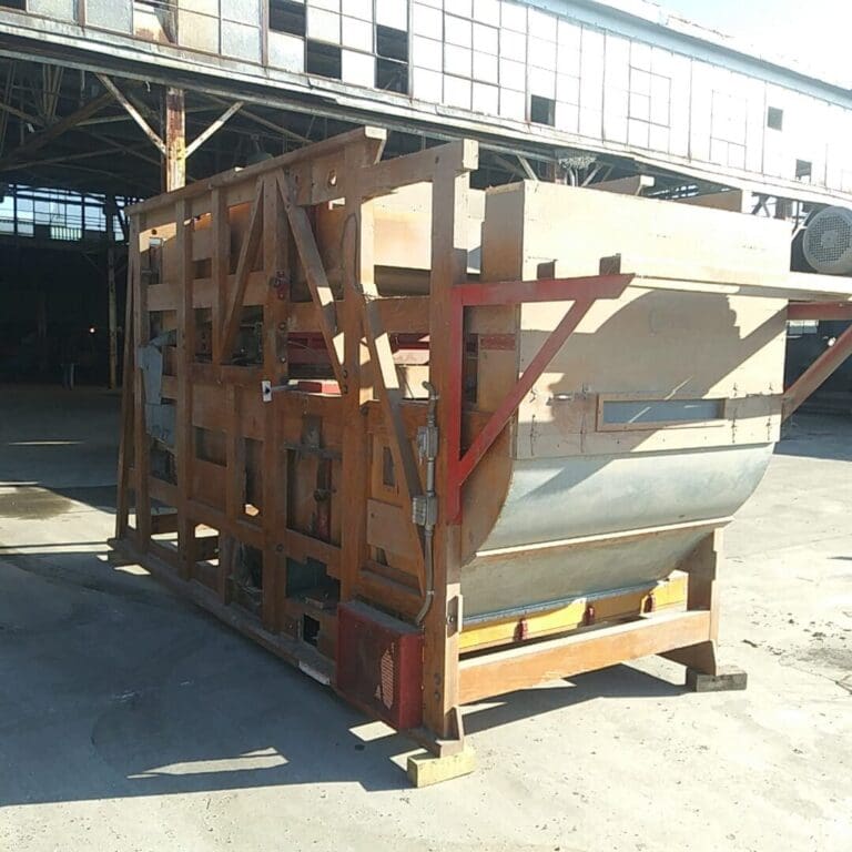A large wooden crate with a metal container on top of it.