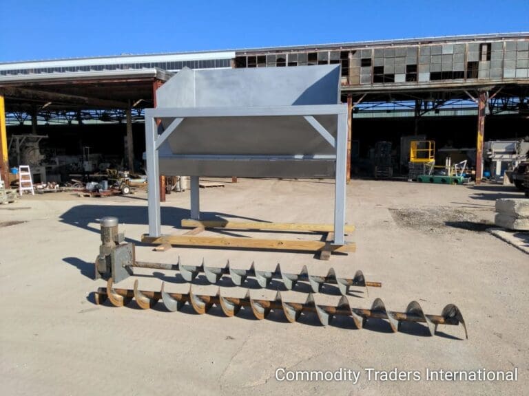 A cement mixer sitting on top of concrete.