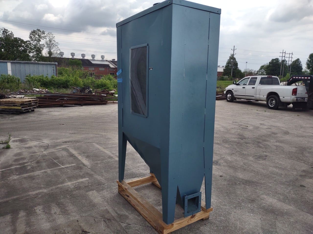 A blue box sitting on top of a wooden crate.