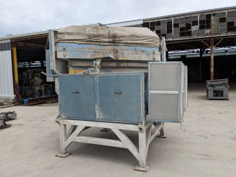 A large metal box sitting in the middle of a lot.