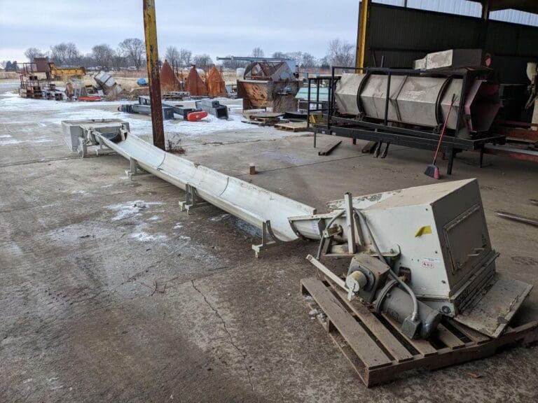 A large white pipe sitting on top of a wooden platform.