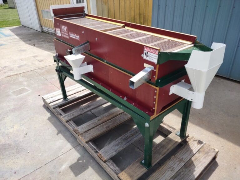 A red and green machine on some pallets