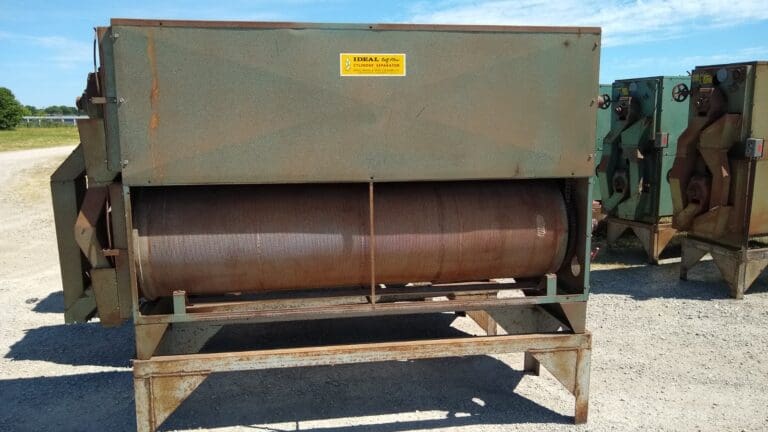 A large brown machine sitting on top of a wooden platform.