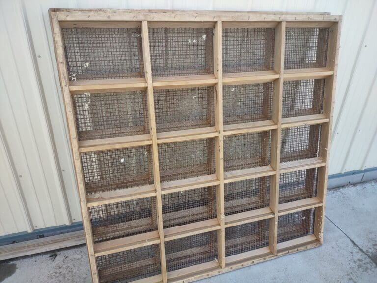 A wooden shelf with baskets on top of it.
