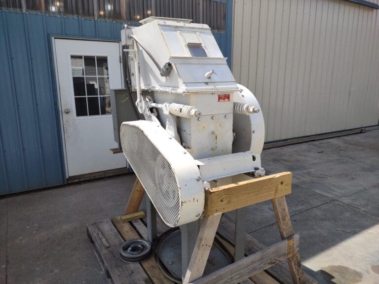 A white machine sitting on top of some wood.