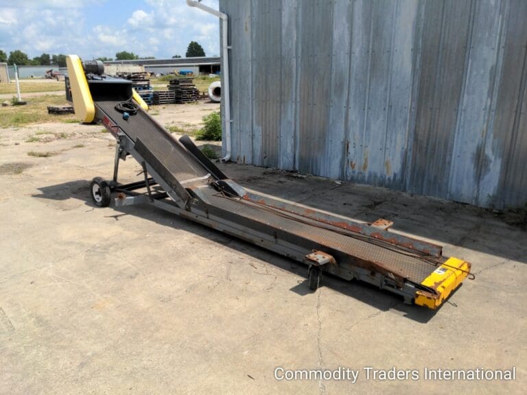 A large metal conveyor belt sitting on top of concrete.
