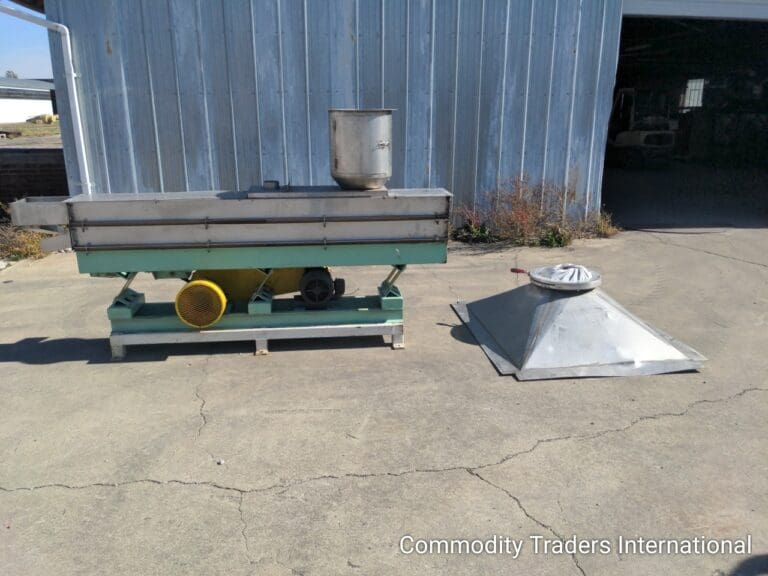A metal tank sitting next to a cement floor.