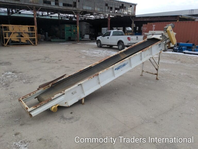 A large white conveyor belt sitting in the middle of a lot.