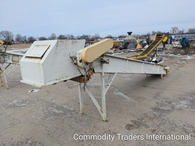 A conveyor belt sitting in the middle of an empty lot.