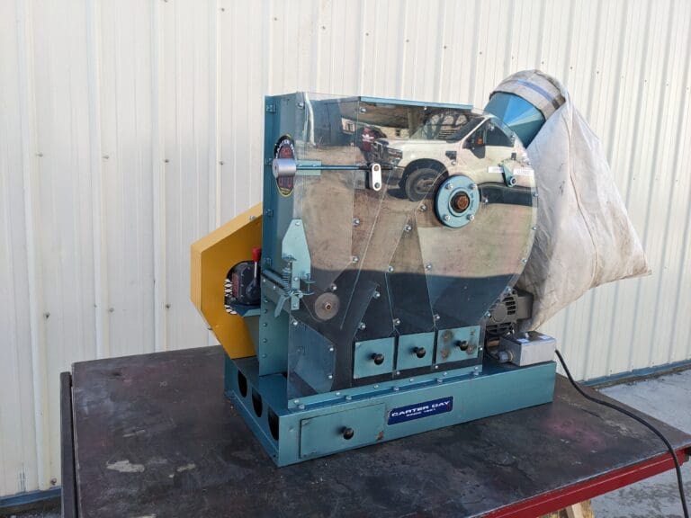 A blue machine with a picture of a truck on it.