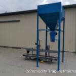 A blue machine is sitting in front of a building.