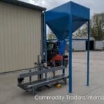 A blue machine with a forklift in the background.