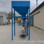 A blue cart with a large metal bin on the side.