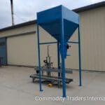 A blue machine stands in front of a building.