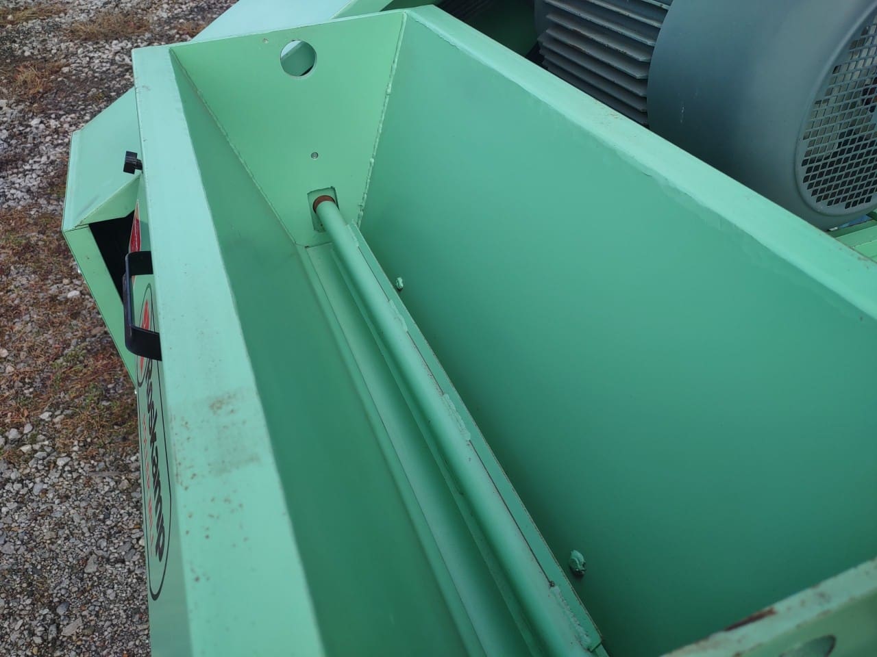 A green dumpster with the lid open.