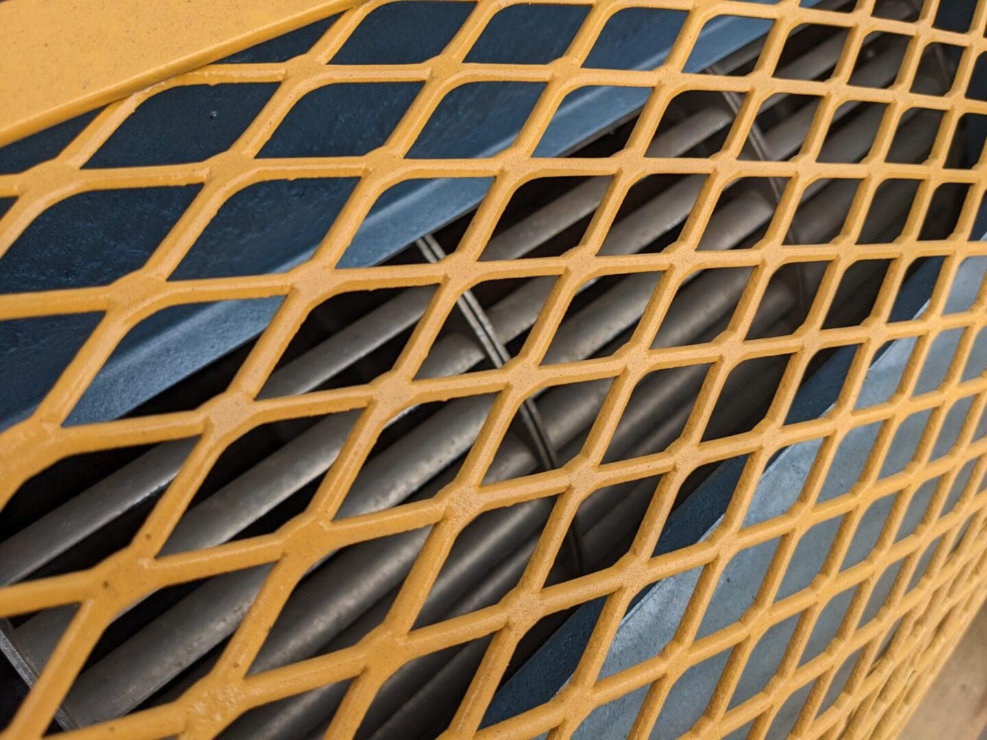 A close up of the grill on an orange car