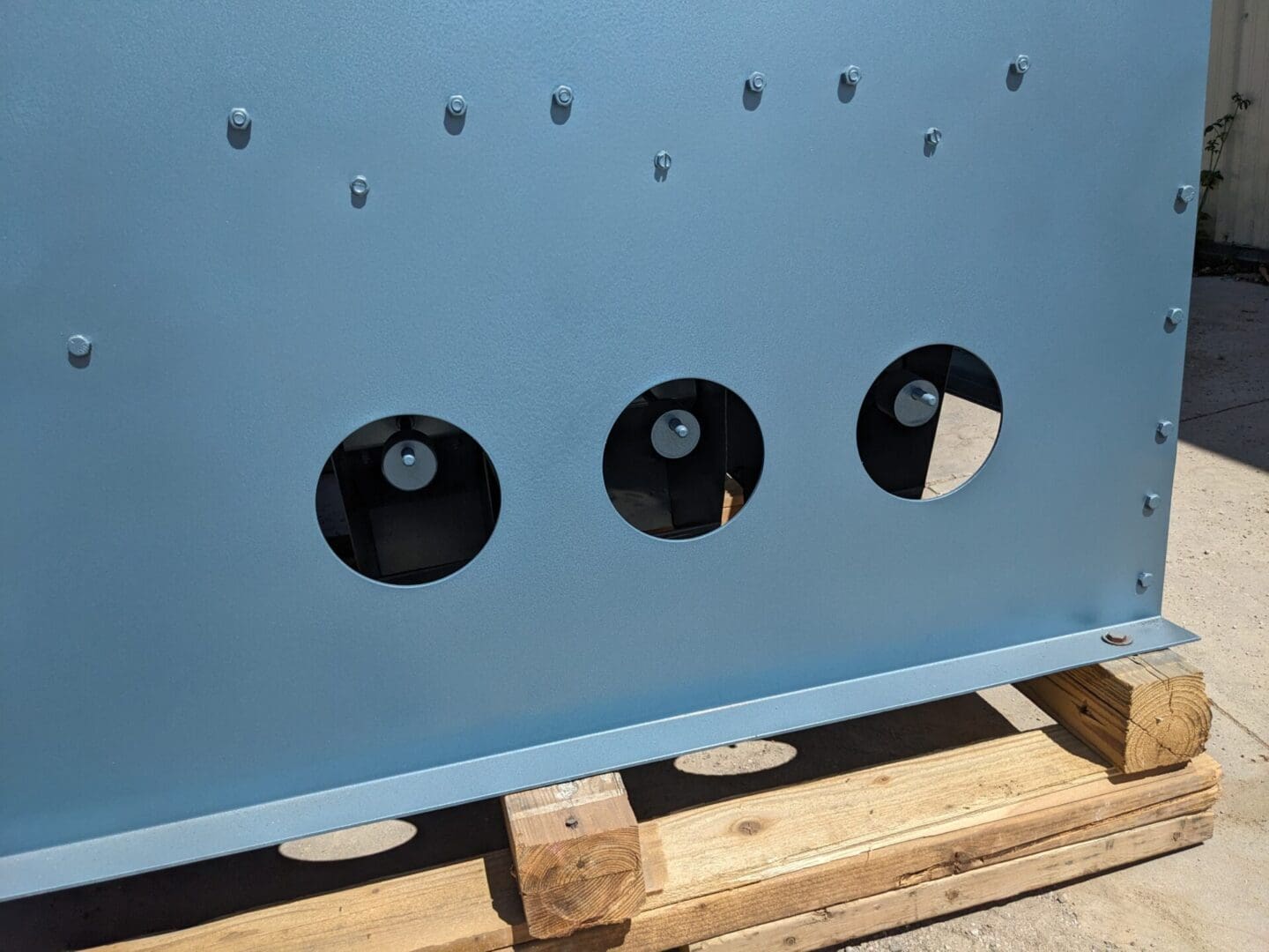 A blue metal box with holes in it.