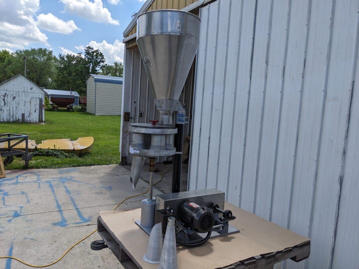 A machine is sitting outside on the ground.