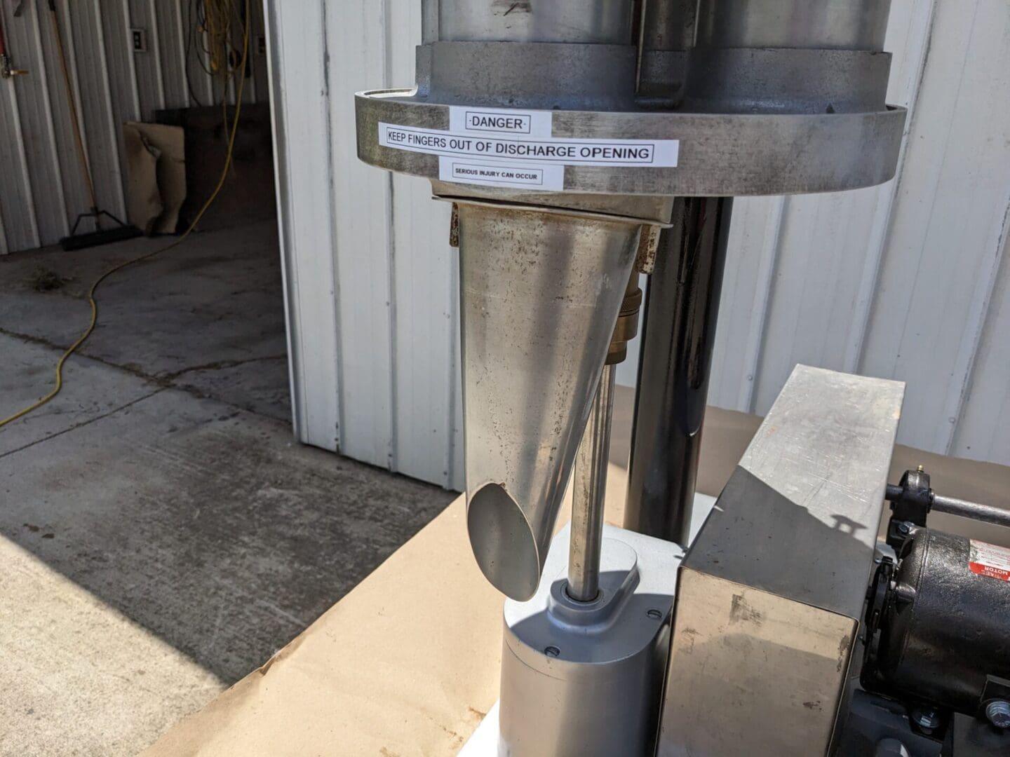 A metal machine with some stickers on it