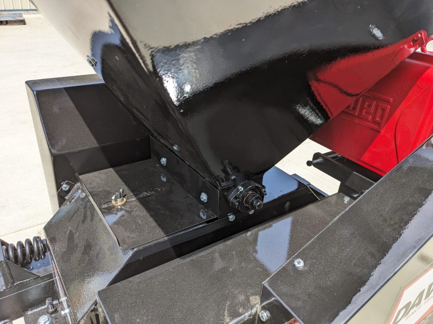 A broken floor with a red bag and some black chairs