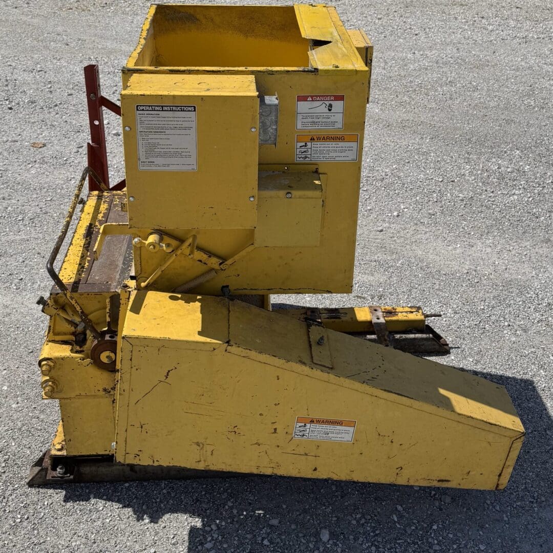 A yellow box sitting on top of the ground.