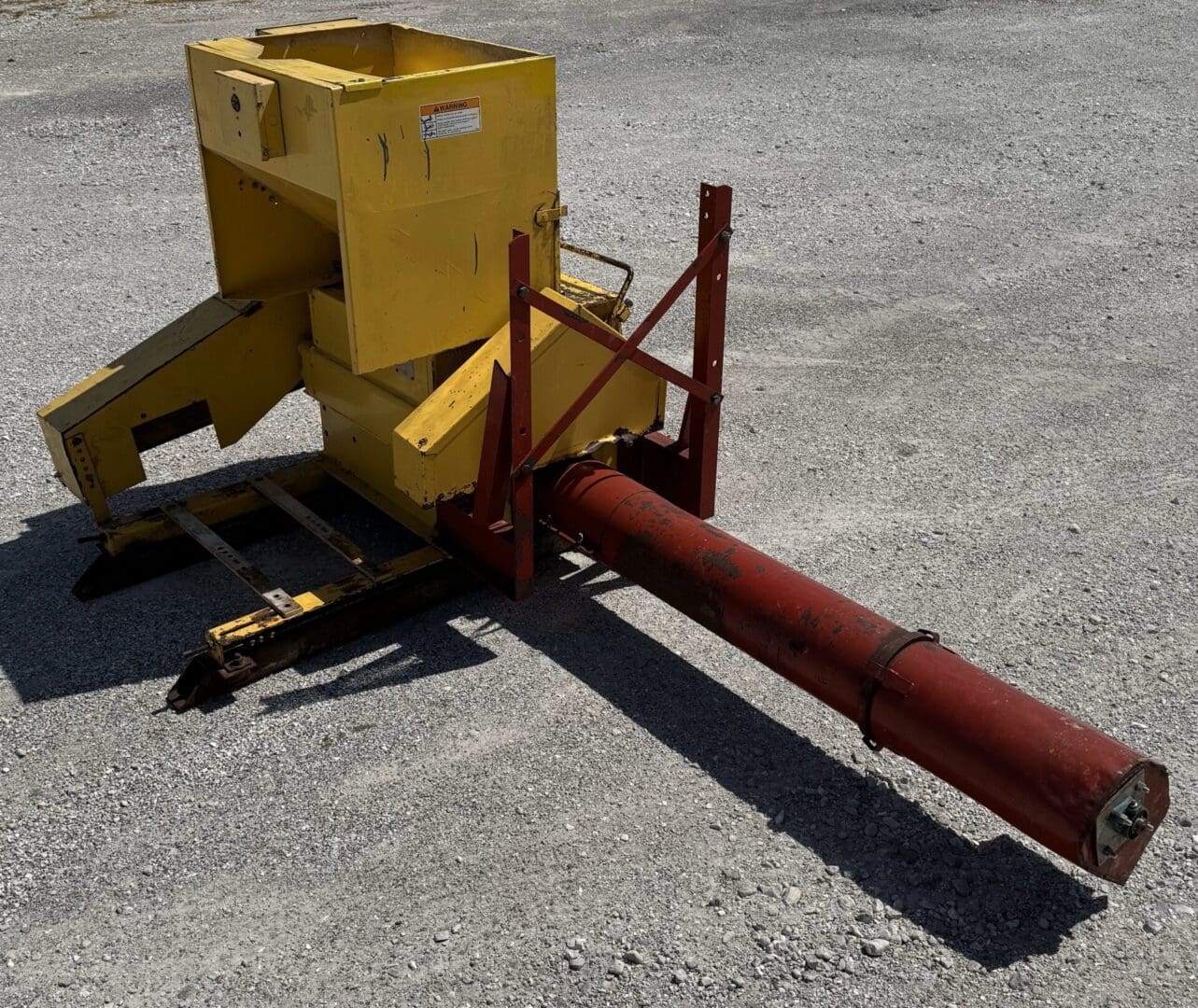 A yellow box sitting on top of the ground.