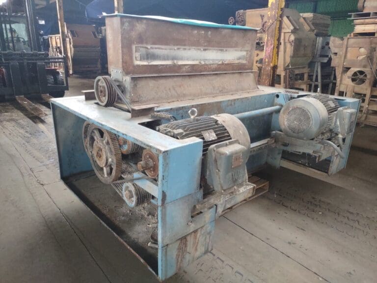 A large machine in the middle of an industrial area.