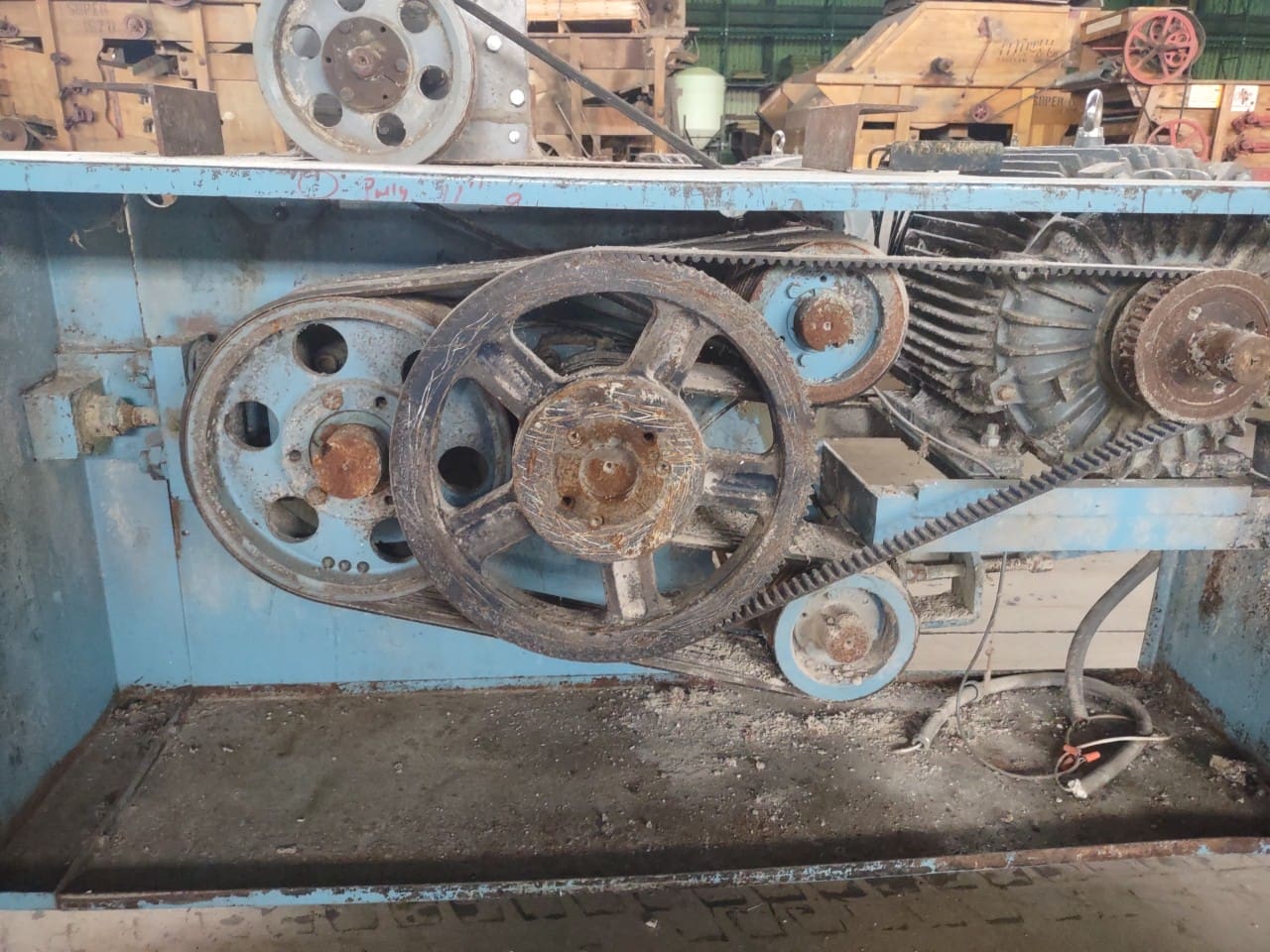 A close up of the gears on an old machine