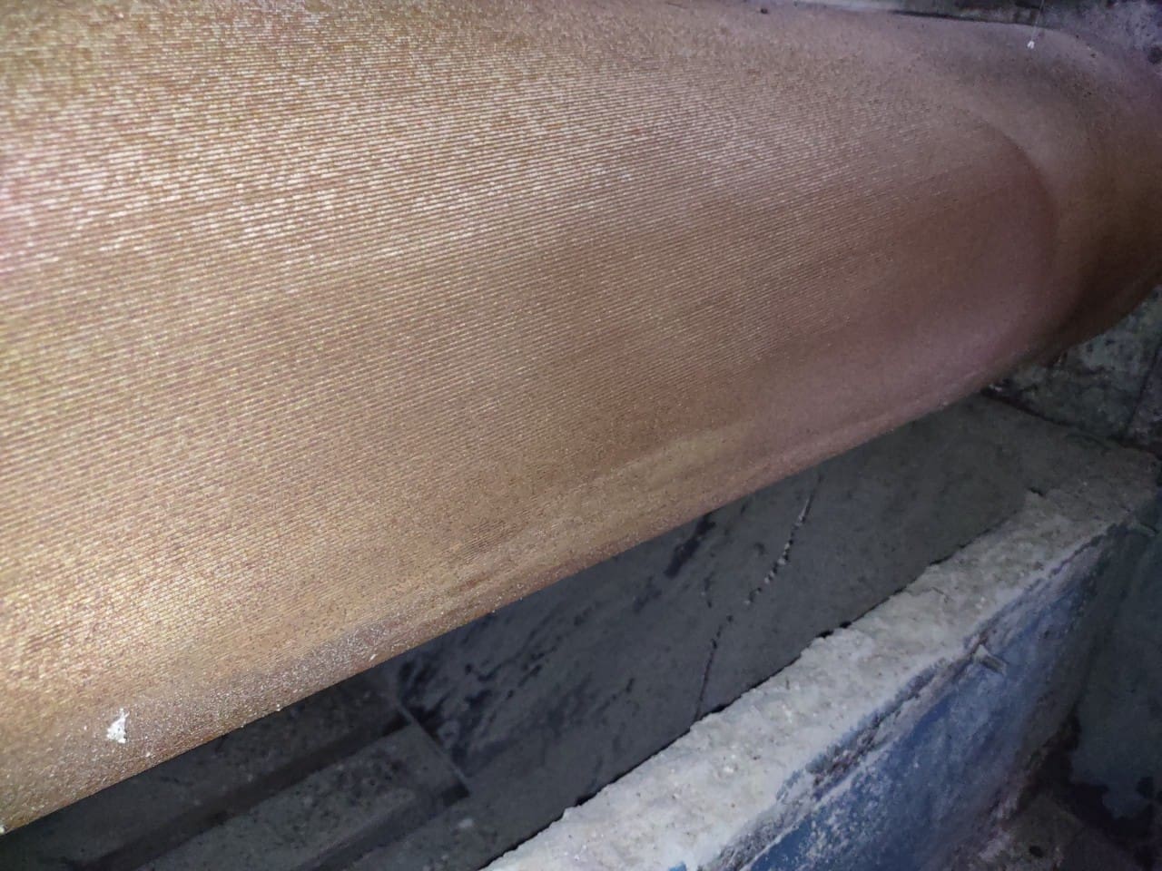 A close up of the bottom of a wooden bench.