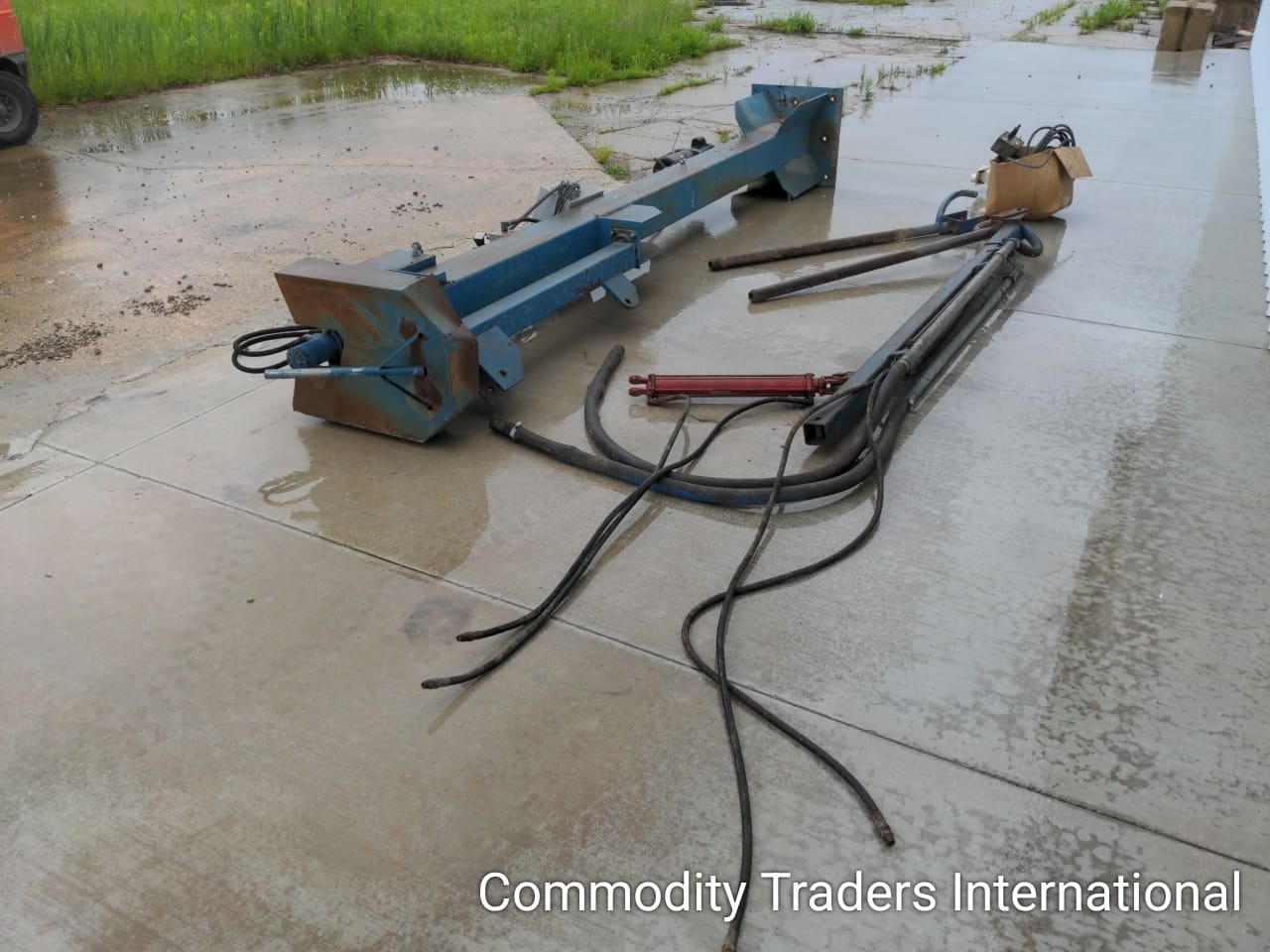 A broken down plow sitting in the middle of a puddle.
