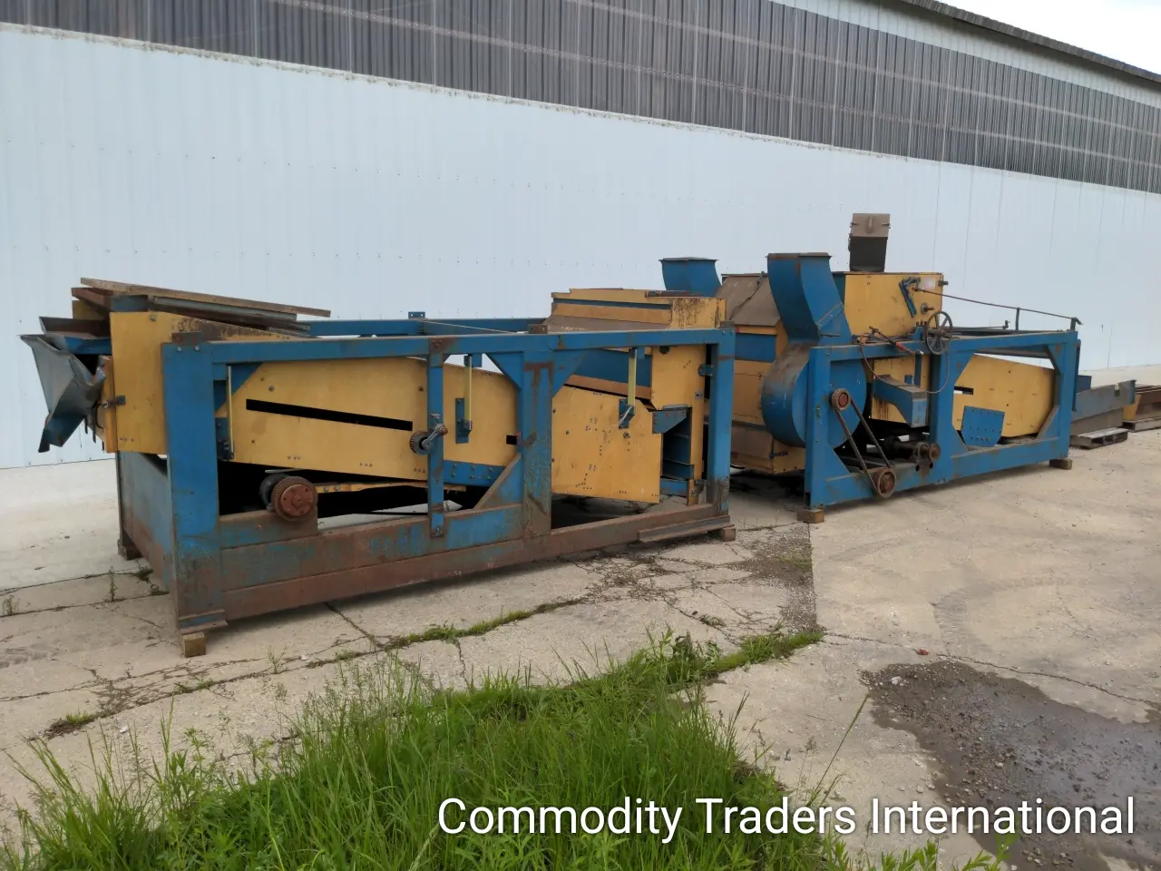 A blue and yellow machine is sitting on the ground.