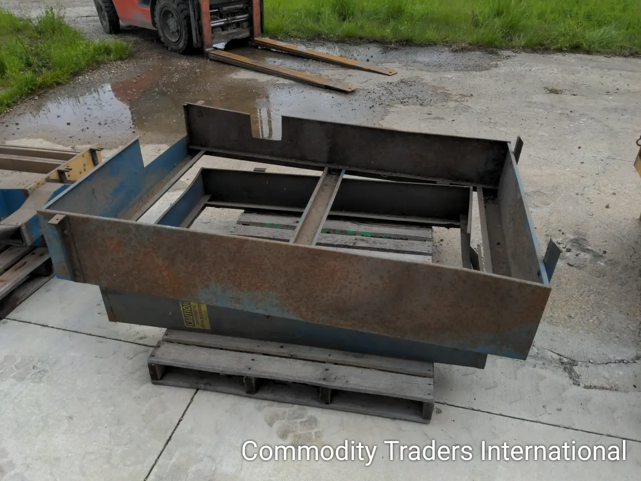 A large metal box sitting on top of concrete.
