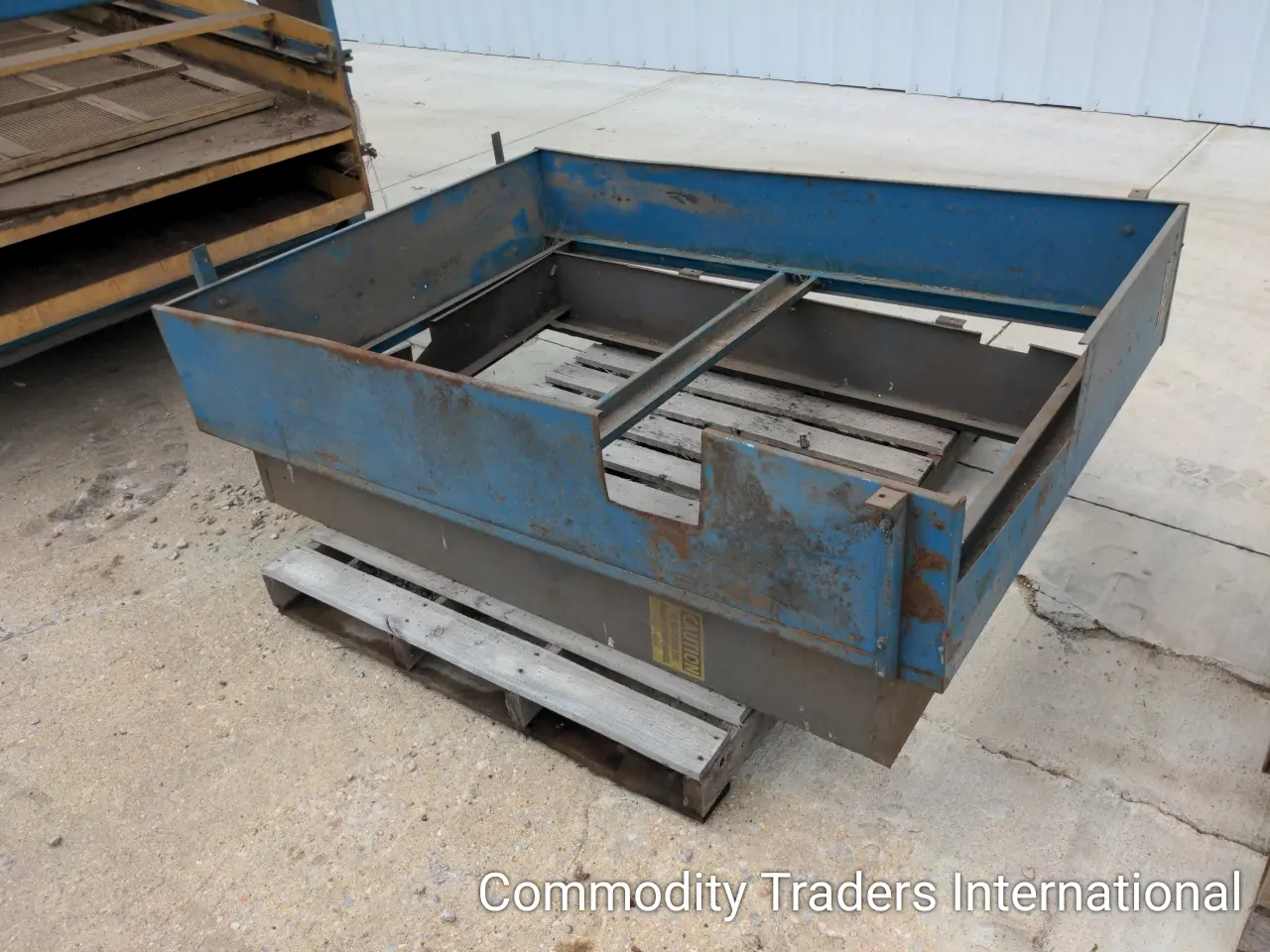 A blue metal box sitting on top of a floor.