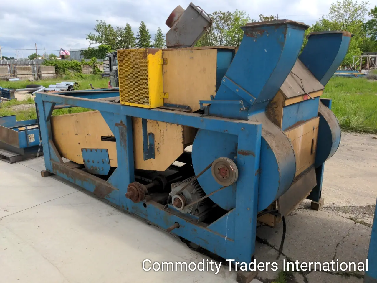A blue machine with some boxes on top of it