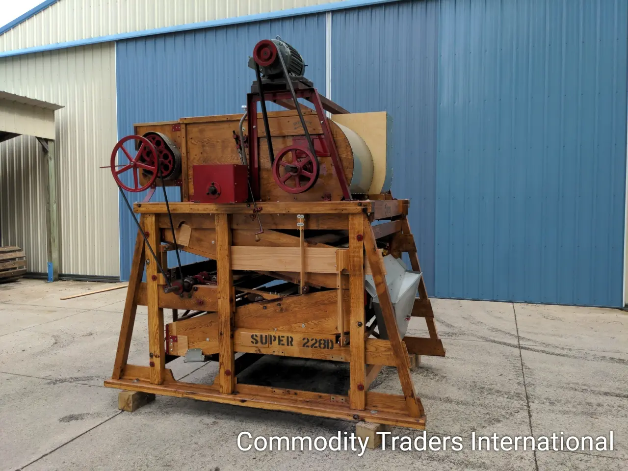 A large wooden cart with two large machinery.