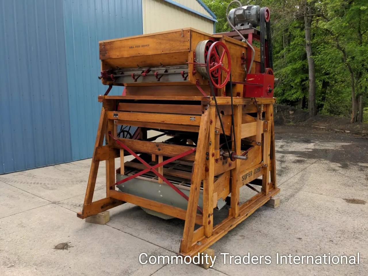 A large wooden machine sitting on top of the ground.