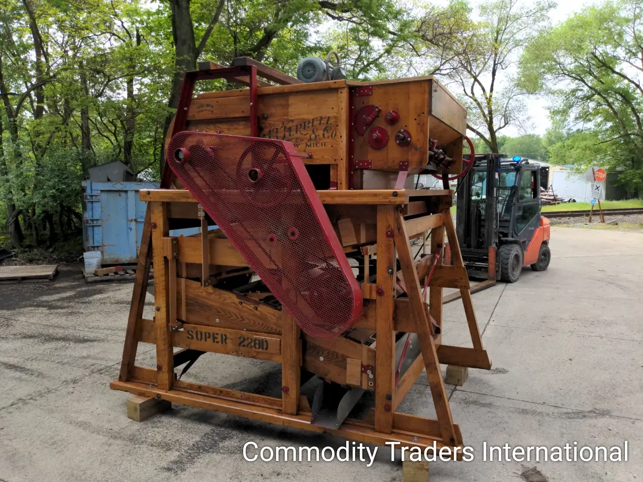 A large wooden machine sitting on top of the ground.