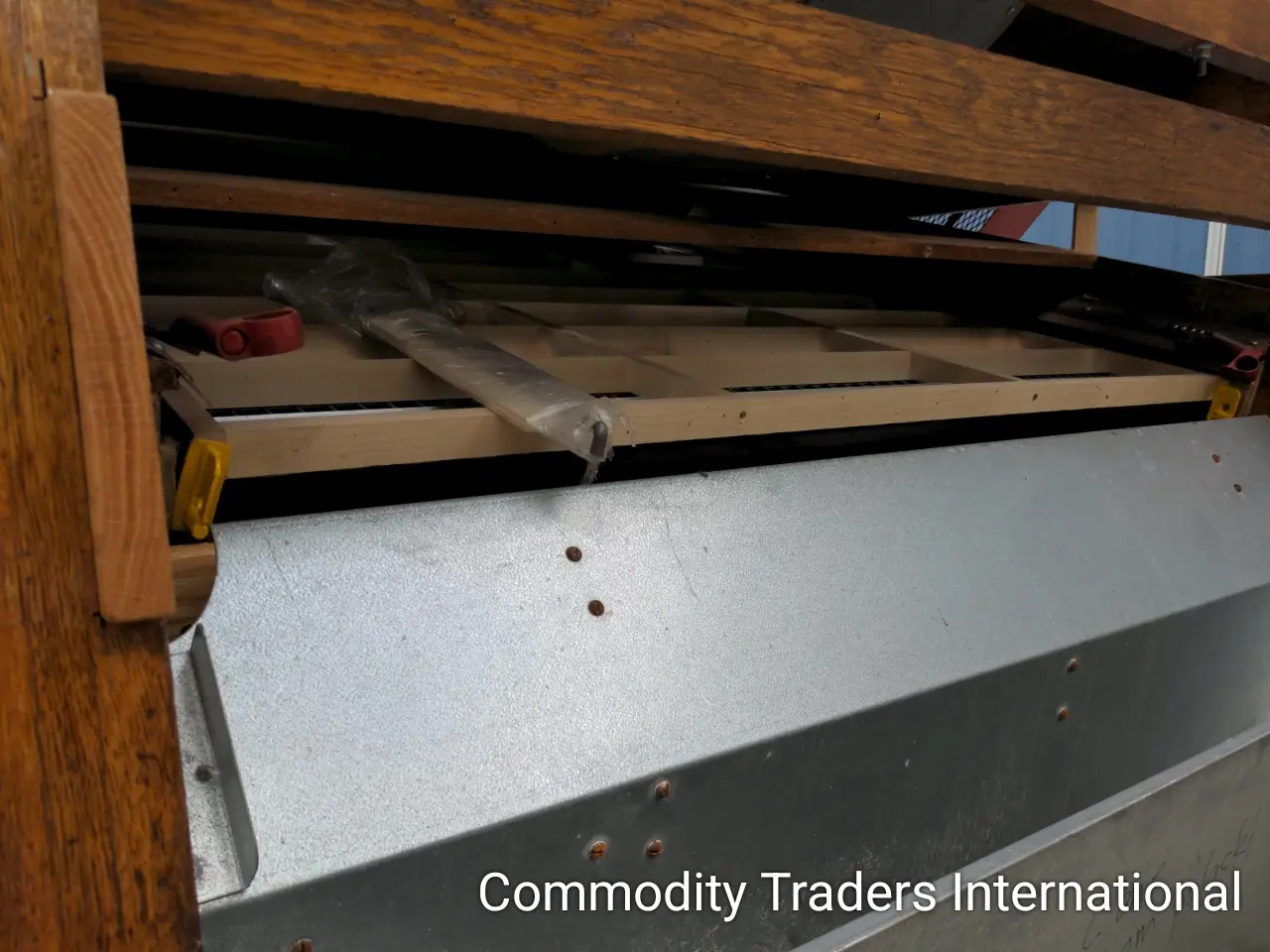 A metal shelf with some wood and other items
