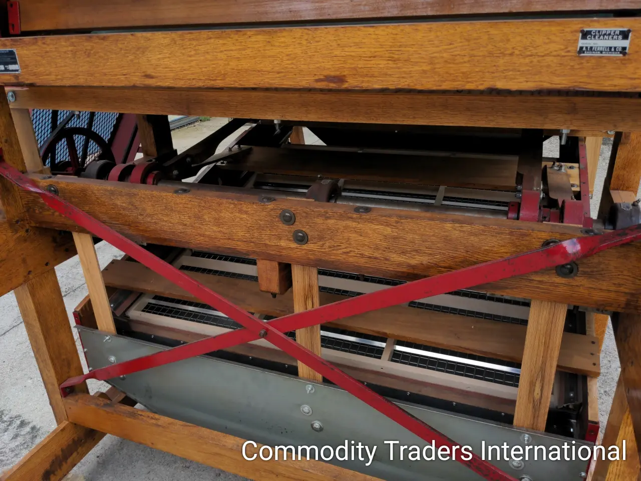 A wooden table with red straps on it.