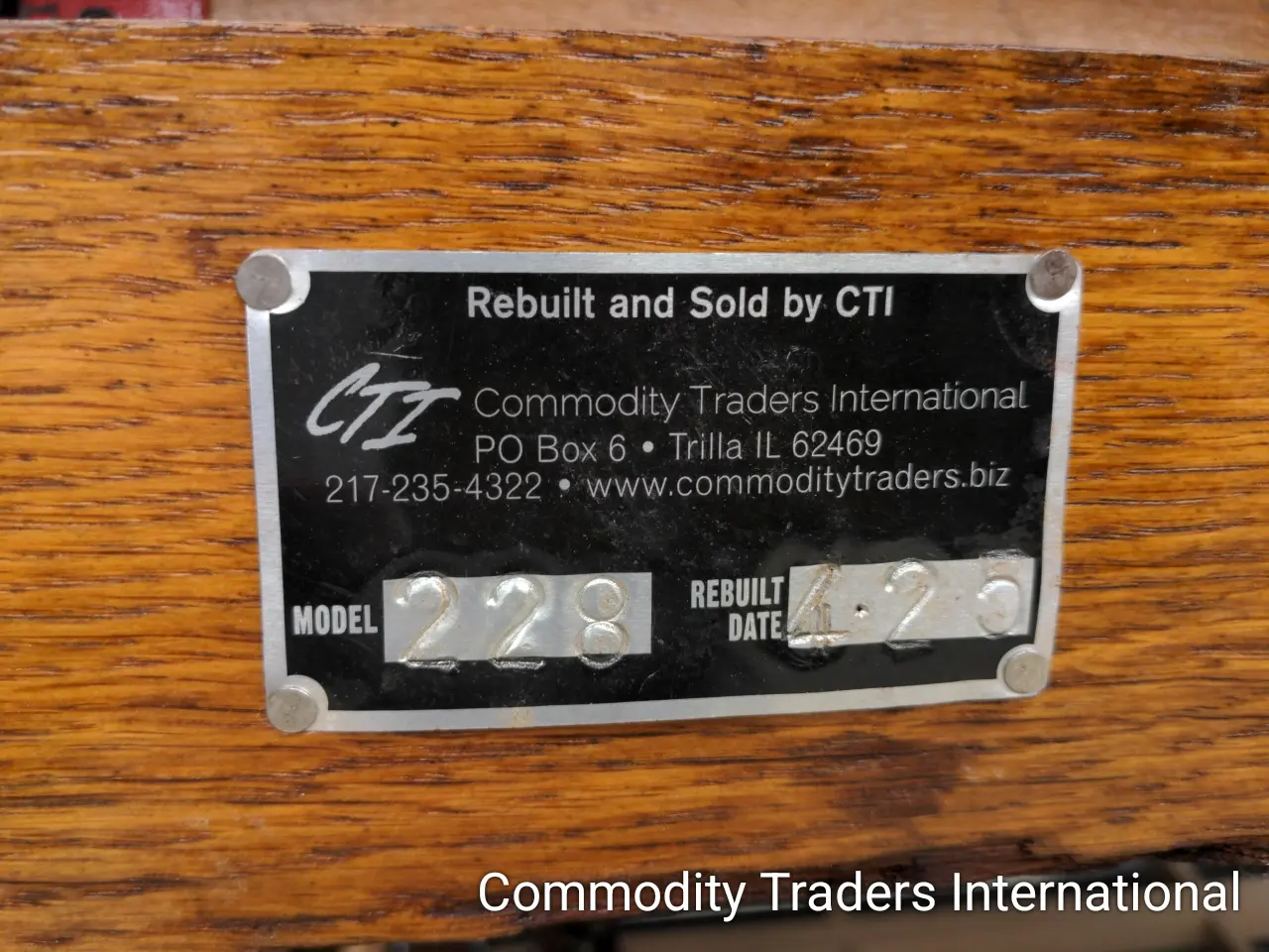 A plaque on the side of a wooden box.