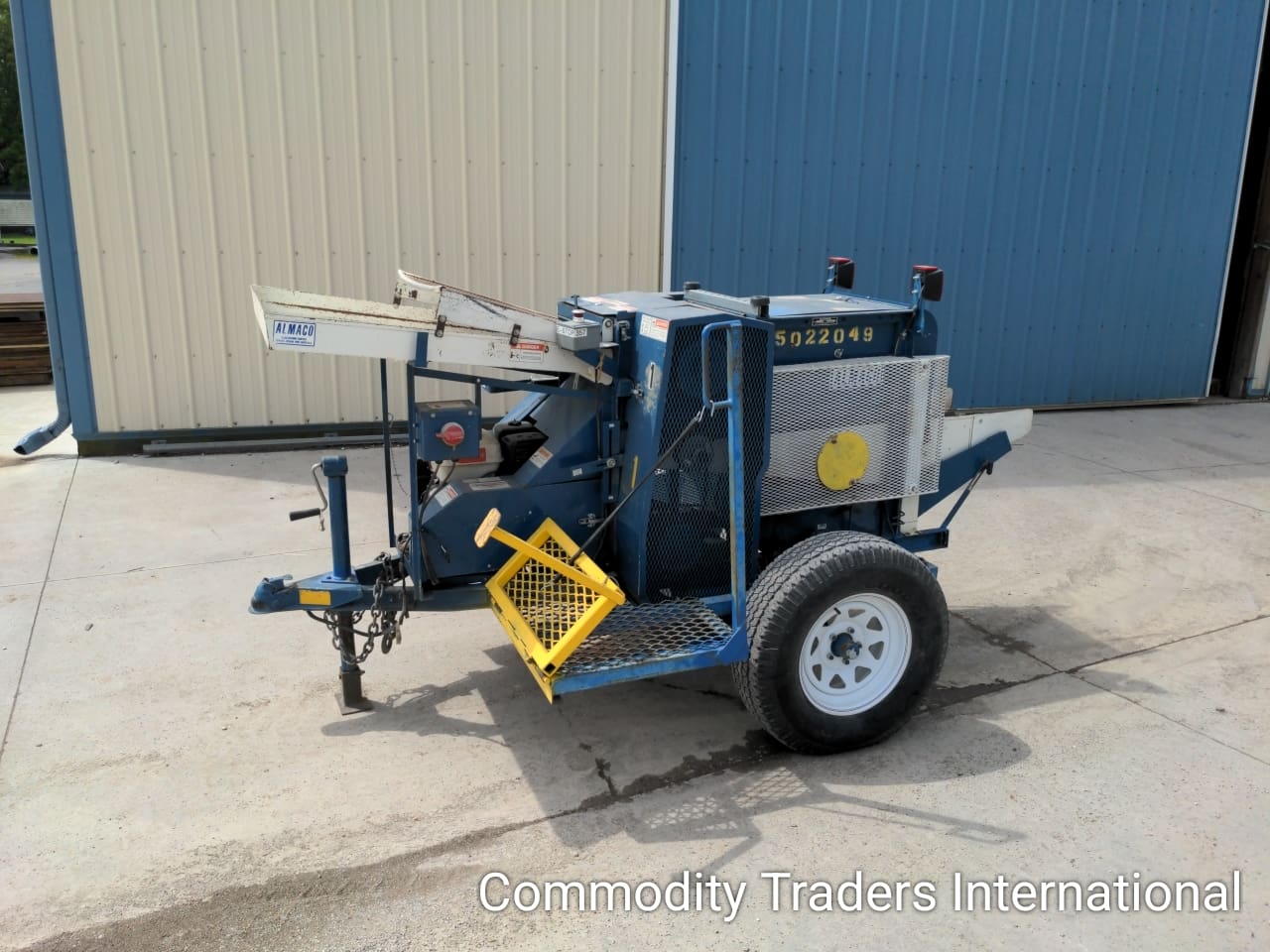 A blue and yellow trailer with a crane on it.