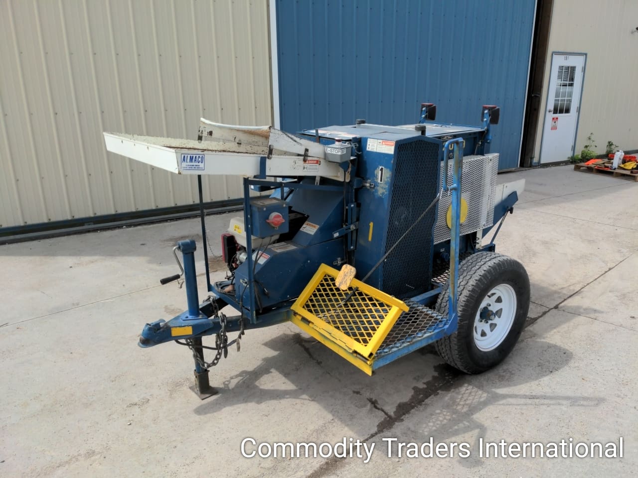 A blue trailer with a yellow handle and wheels
