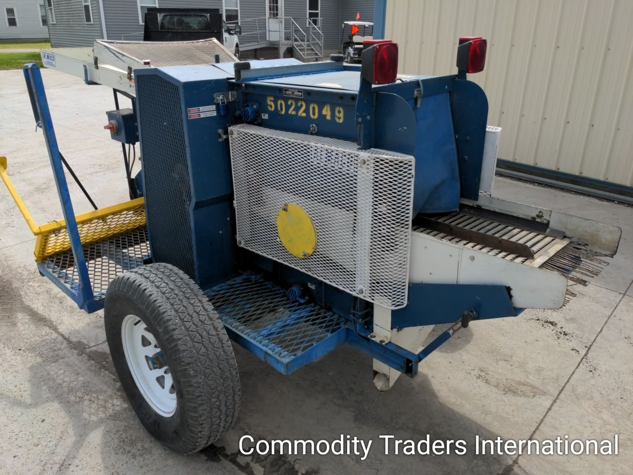 A blue trailer with a yellow sign on it.