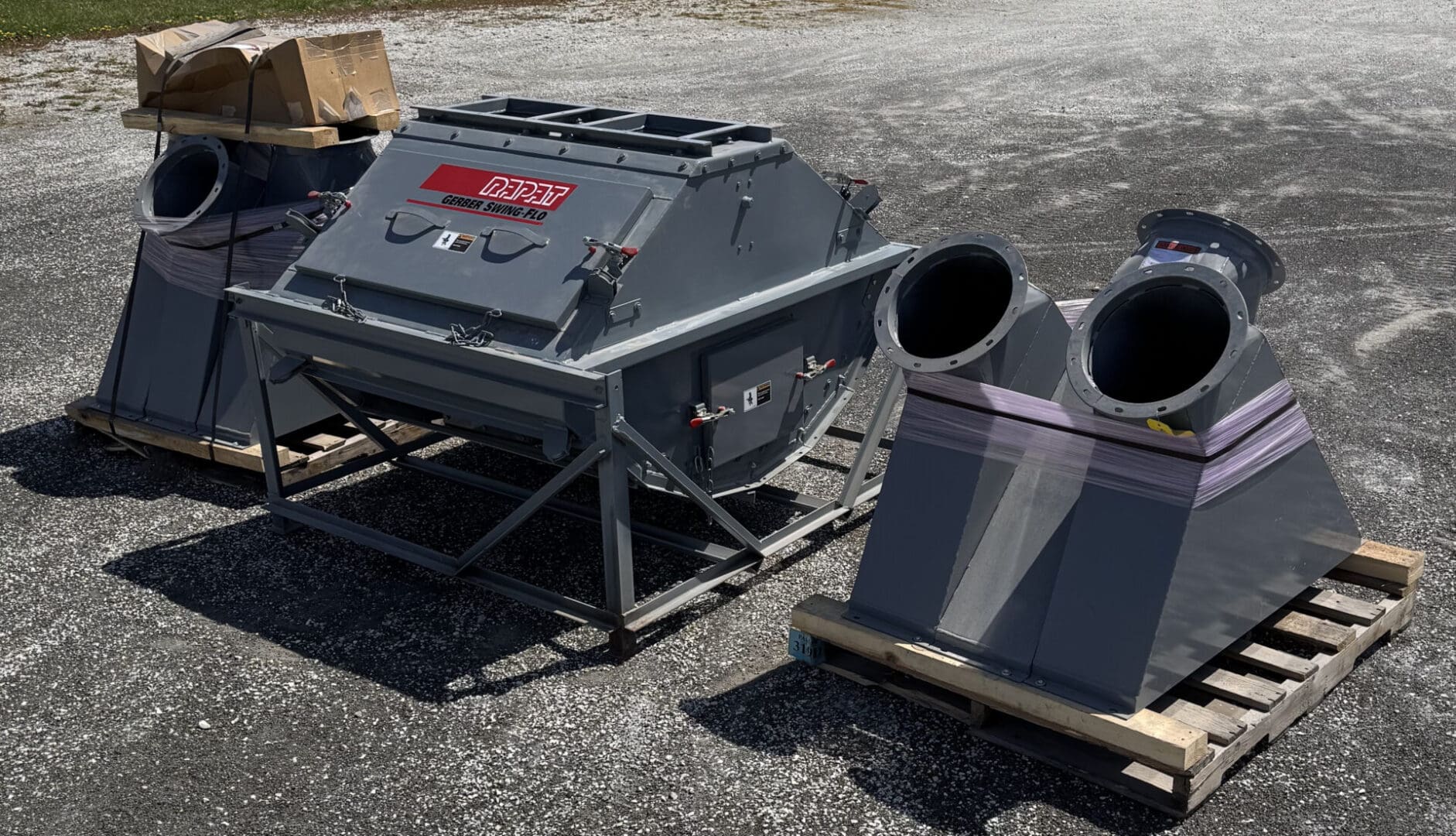 A large metal machine sitting on top of a cement ground.