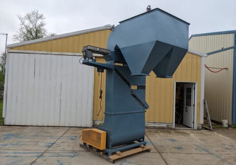 A large blue machine is sitting in the middle of a building.
