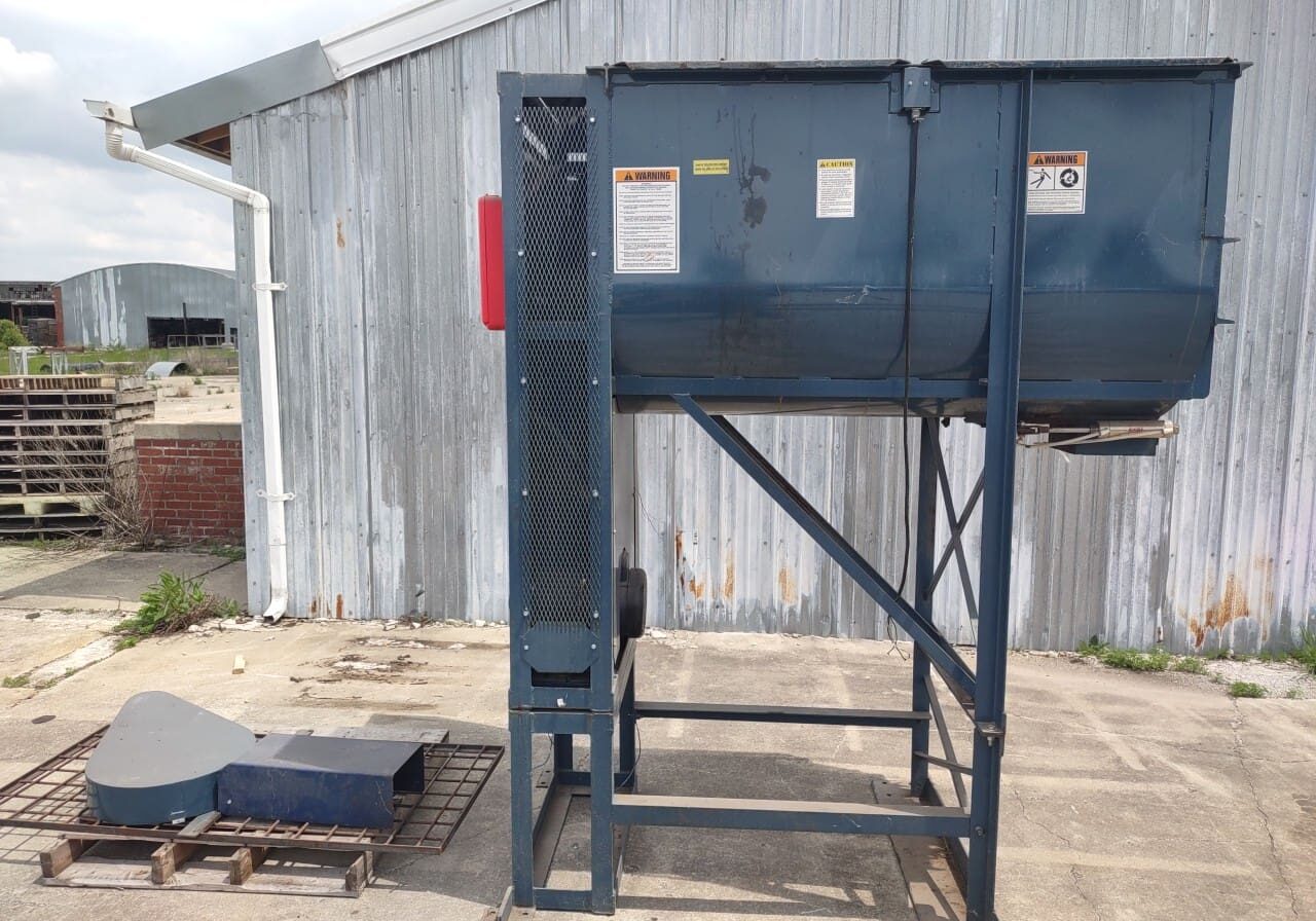 A large metal machine sitting on top of concrete.