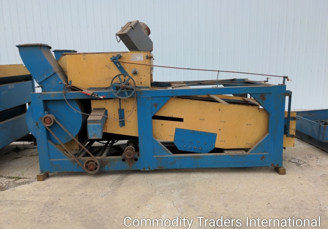 A blue and yellow machine is sitting in the dirt.