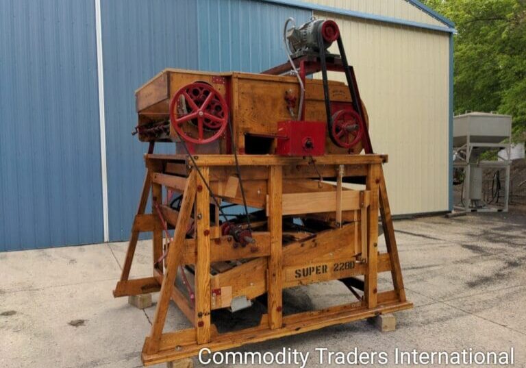 A large wooden machine sitting on top of a cement floor.